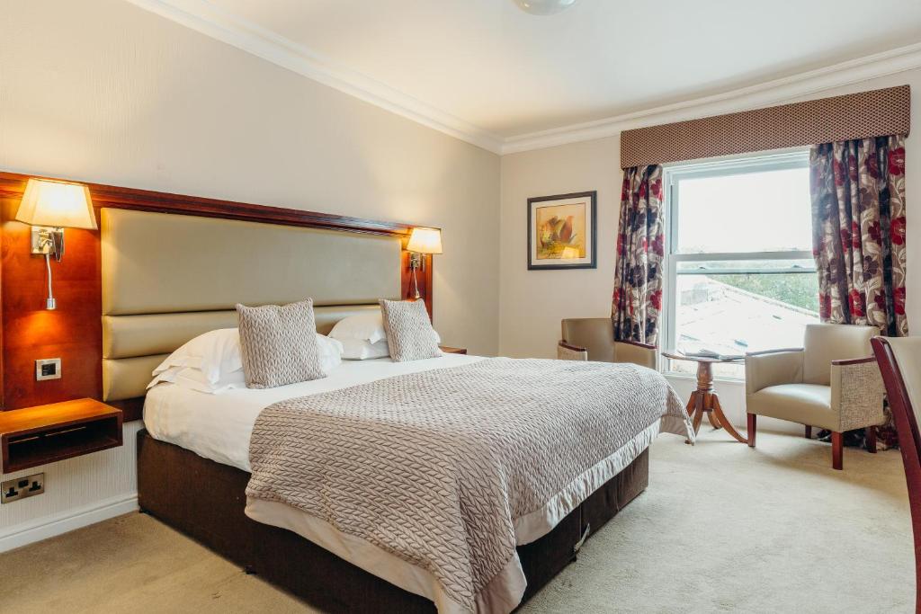 a bedroom with a large bed and a window at Crown Spa Hotel Scarborough by Compass Hospitality in Scarborough