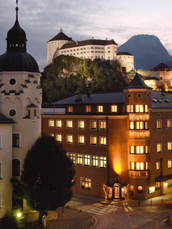 a group of buildings with a mountain in the background at Hotel Andreas Hofer in Kufstein