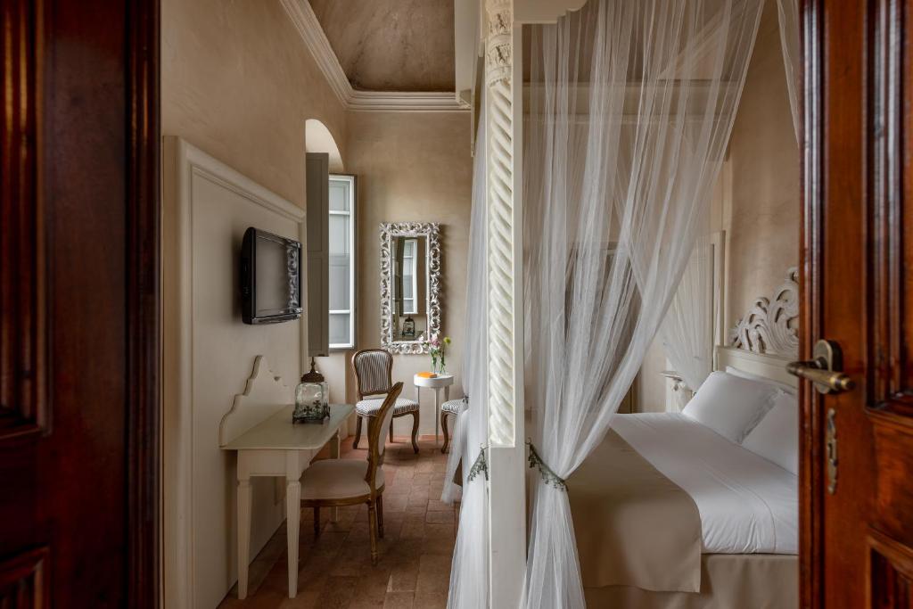 Postel nebo postele na pokoji v ubytování Hotel Palazzo Novello