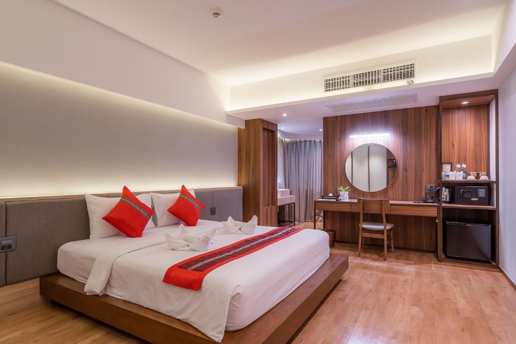 a bedroom with a large bed and a large window at True Siam Phayathai Hotel - SHA Extra Plus Certified in Bangkok