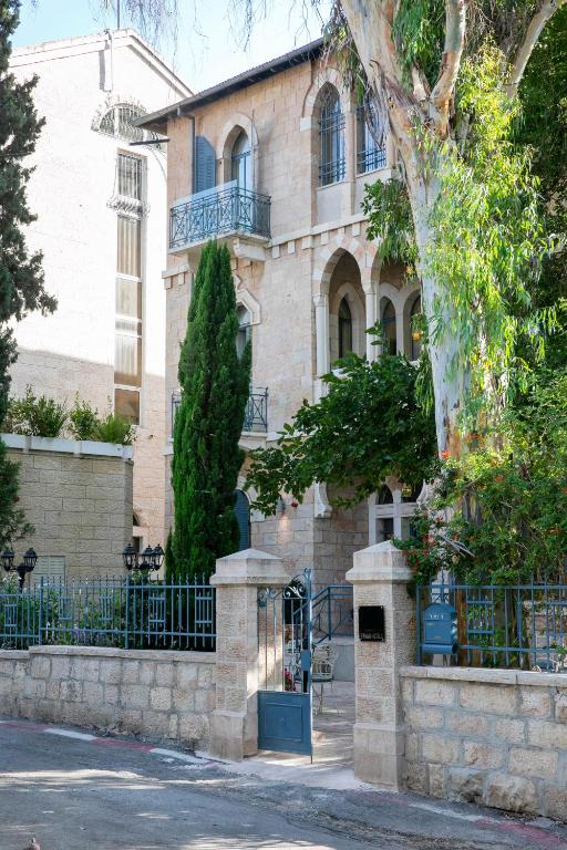 a building with a gate in front of it at Villa Brown Moshava - a member of Brown Hotels in Jerusalem