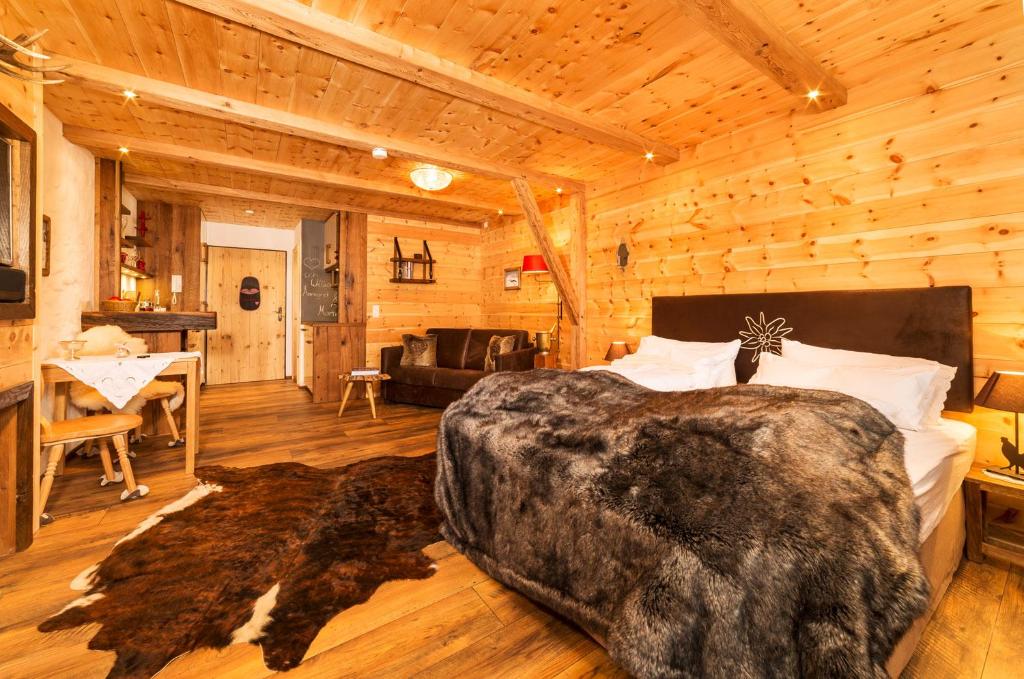 a bedroom with a bed in a log cabin at Chalet Harmonie in Inzell