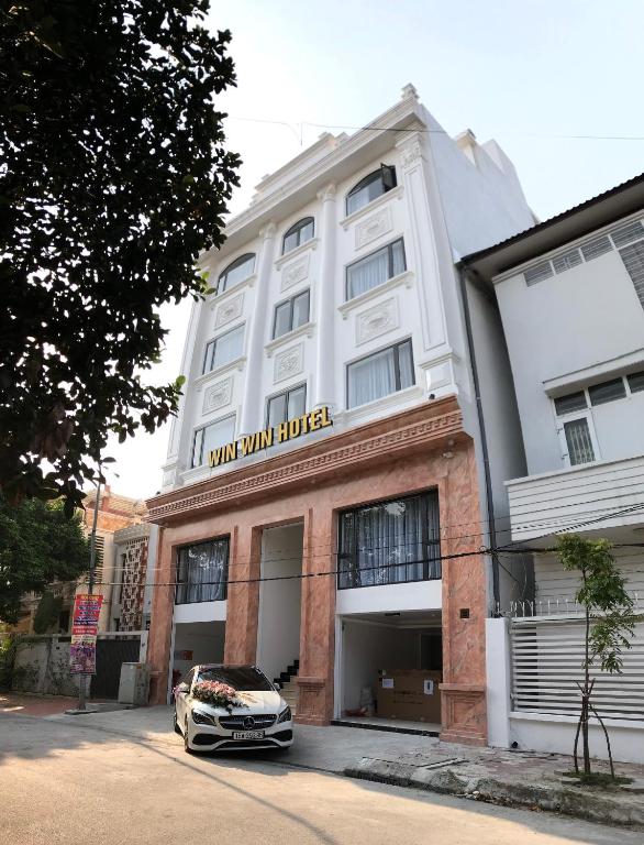 a car parked in front of a building at Win Win Hotel - Khách Sạn Hải Phòng in Hai Phong