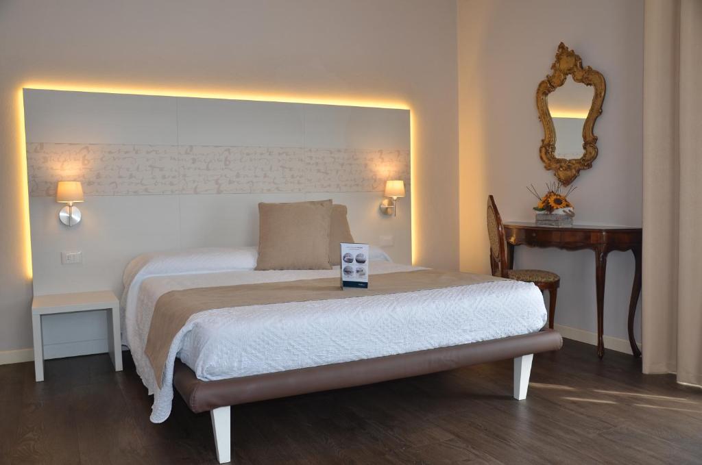 a bedroom with a bed and a mirror on the wall at H2o in Sirmione