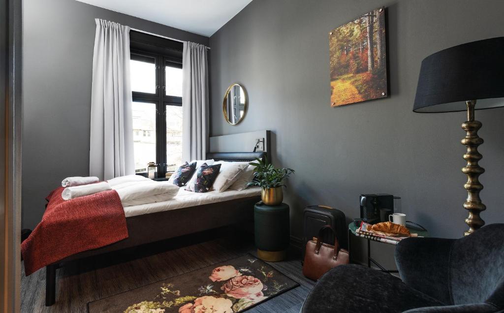 a bedroom with a bed and a window at Hotel Filip in Oslo