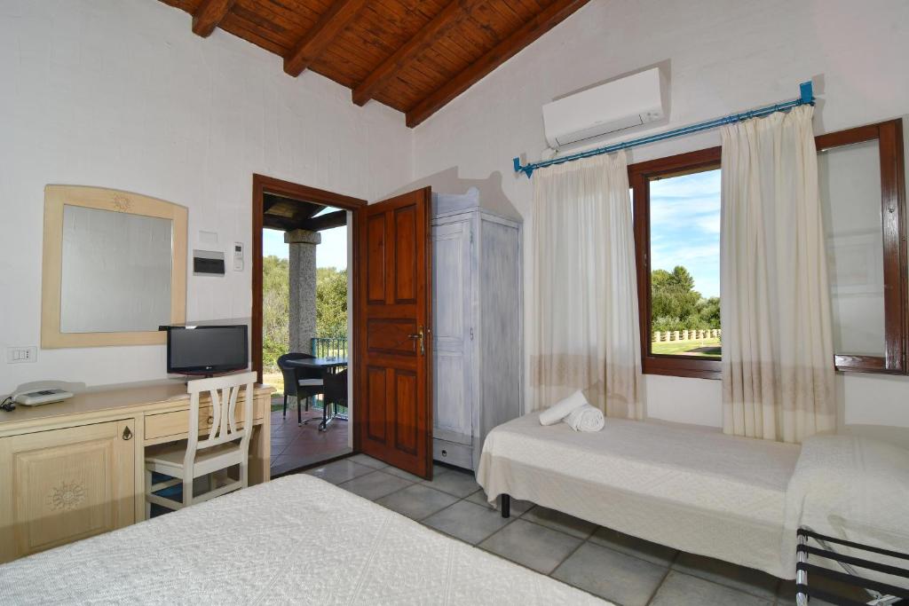 Postel nebo postele na pokoji v ubytování Li Suari Club Village