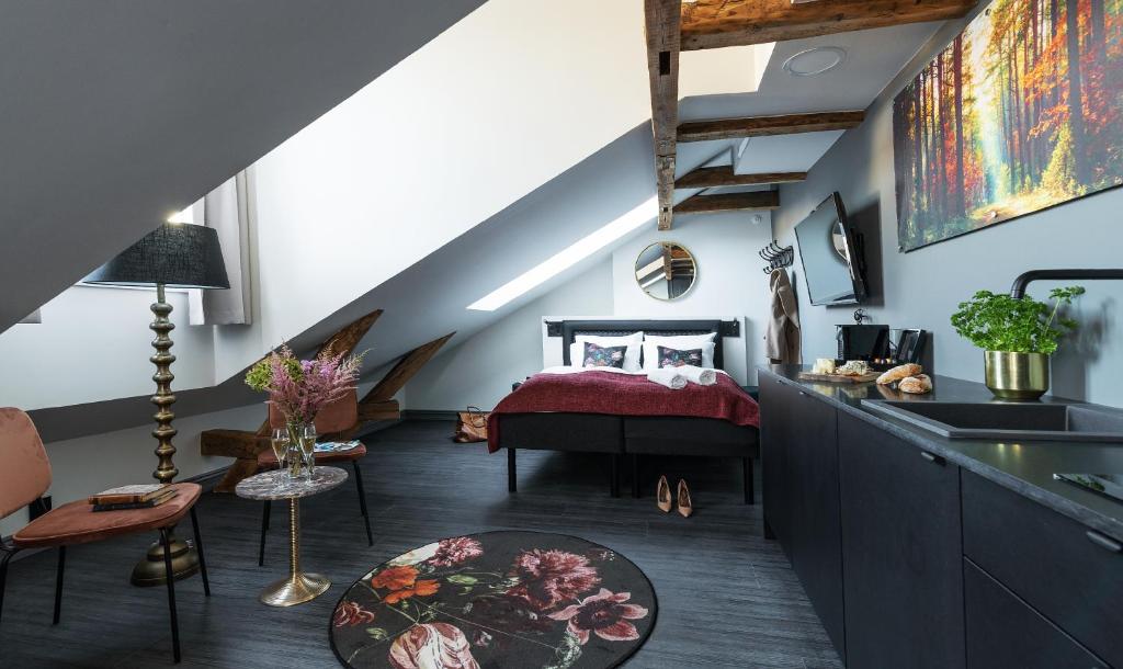 a bedroom with a bed and a sink in a room at Hotel Filip in Oslo