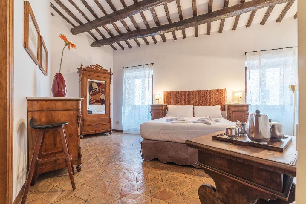 a bedroom with a bed and a desk in a room at By the charming Piazza Navona - FromHometoRome in Rome