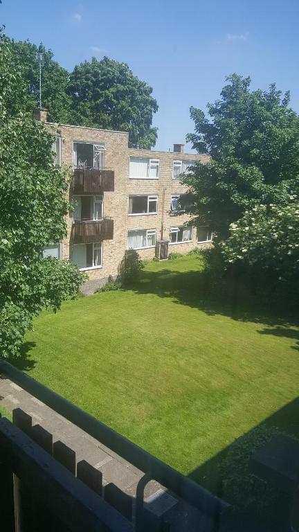 an apartment building with a green lawn in front of it at 38 Cambanks 2 double bedroom apartment in Cambridge