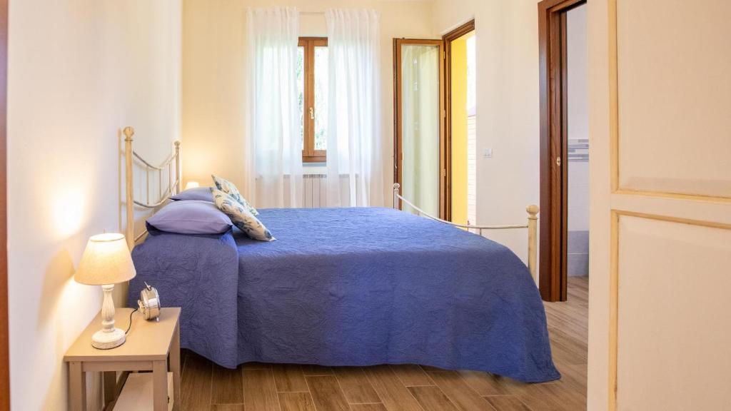 Łóżko lub łóżka w pokoju w obiekcie Le Rime di Campagna