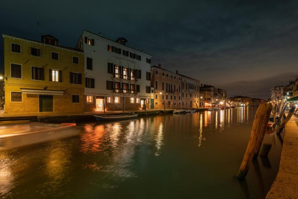 a view of a canal at night with buildings at Ca' Bonfadini Historic Experience in Venice