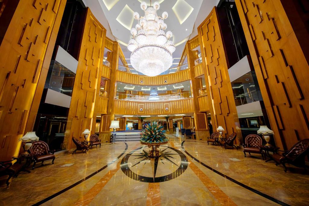 a large lobby with a christmas tree in the middle at Royal Swiss Lahore in Lahore