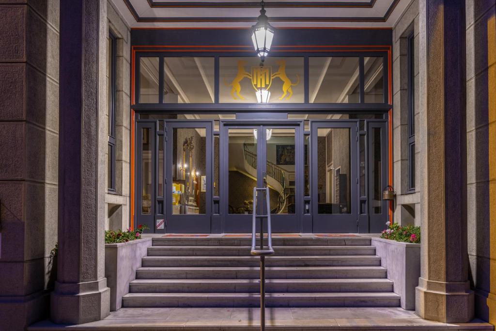 a front door of a building with stairs at Hotel Meurice in Calais