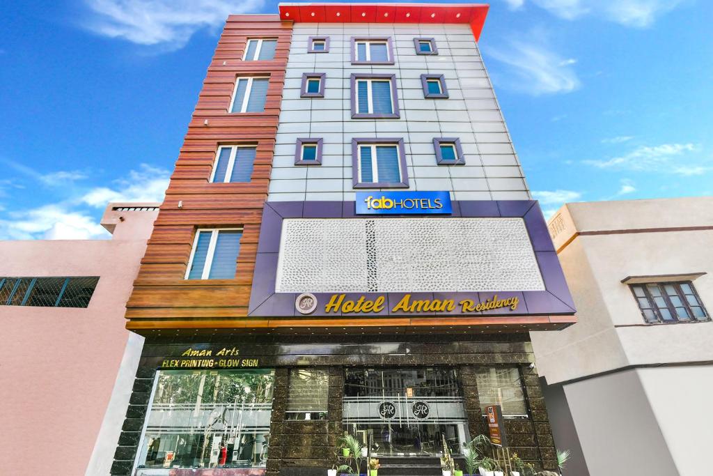 a building with a sign on the front of it at FabHotel Aman Residency Sharifpura in Amritsar