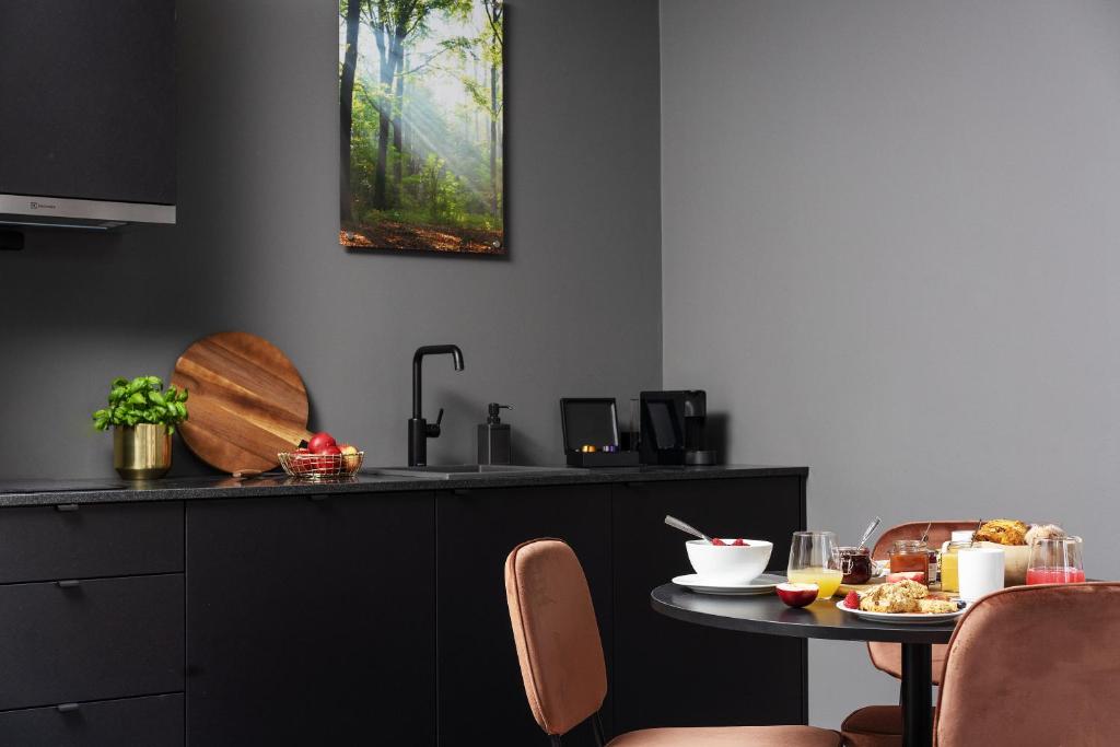 a kitchen with a table with a plate of food on it at Hotel Filip in Oslo