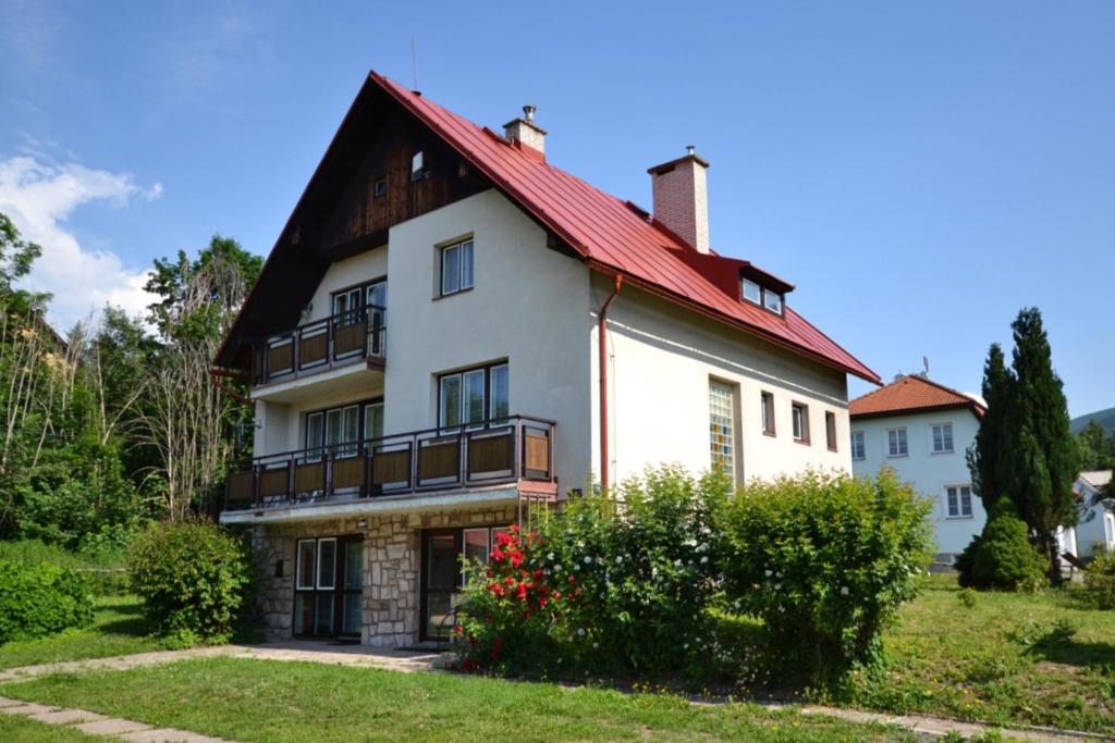 a large white house with a red roof at Chalupa Slunečná in Černý Dŭl