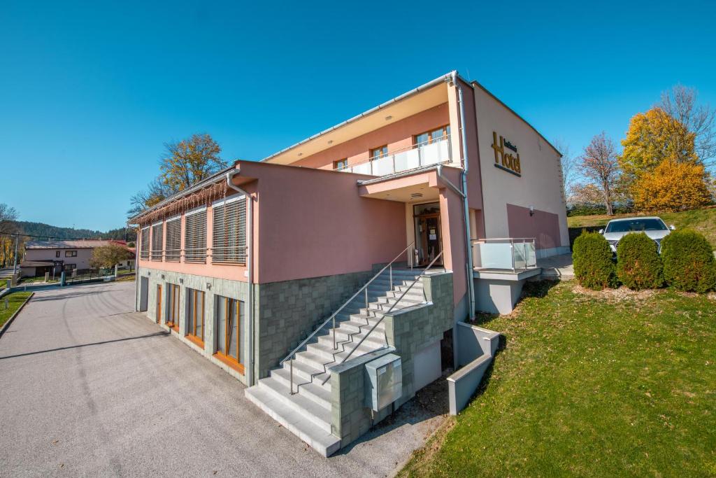 a building with a staircase on the side of it at Hotel Lučivná in Lučivná