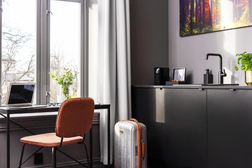 an office with a desk and a chair and a computer at Hotel Filip in Oslo