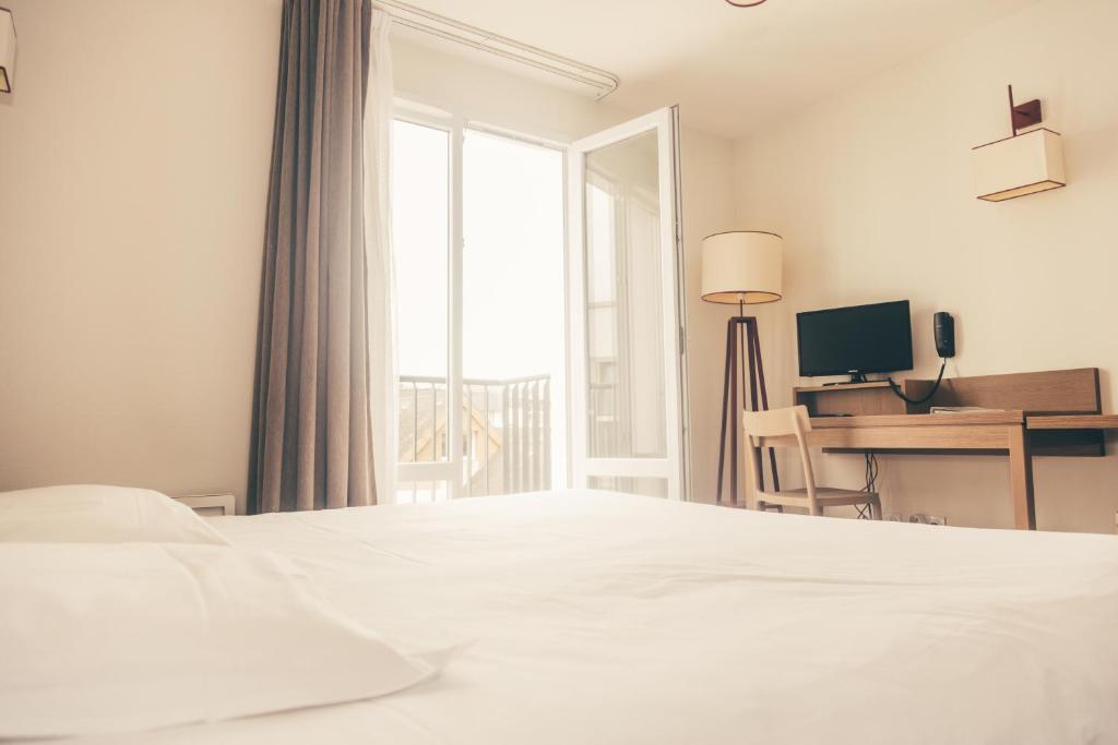 Postel nebo postele na pokoji v ubytování Terres de France - Appart'Hotel Quimper Bretagne