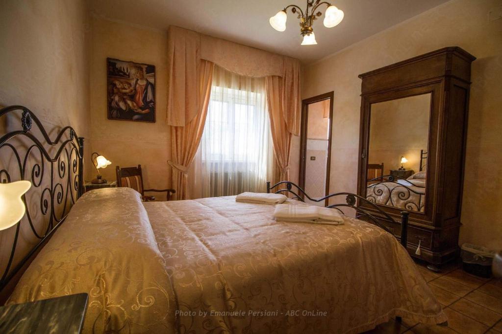 Postel nebo postele na pokoji v ubytování Agriturismo Baldassari