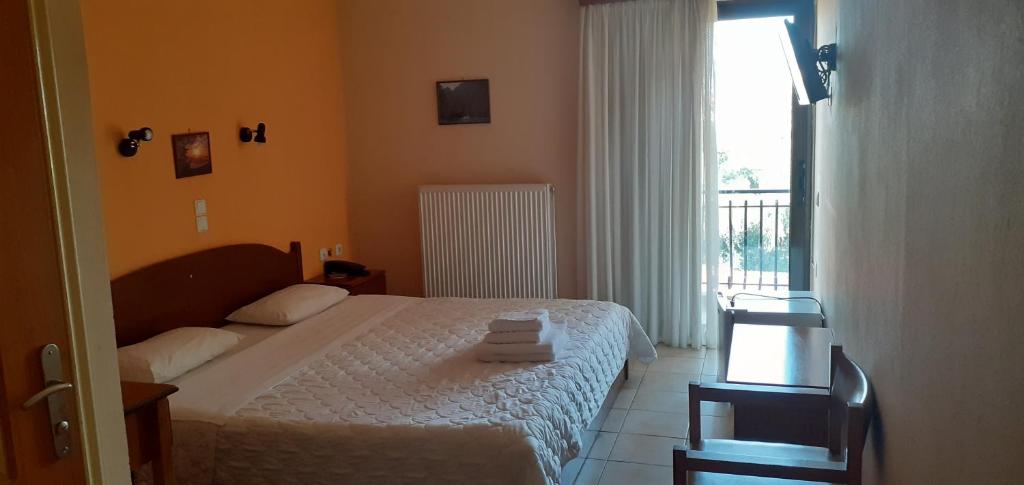 Postel nebo postele na pokoji v ubytování Hotel Themisto
