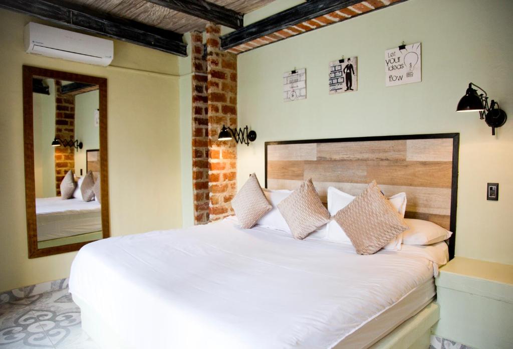 
A bed or beds in a room at Maloka Boutique Hostel
