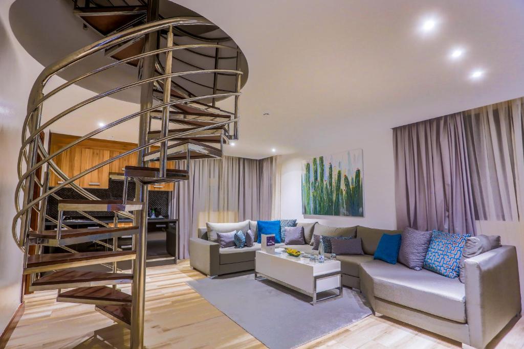 a living room with a spiral staircase in a house at SBN Suite Hôtel in Tangier