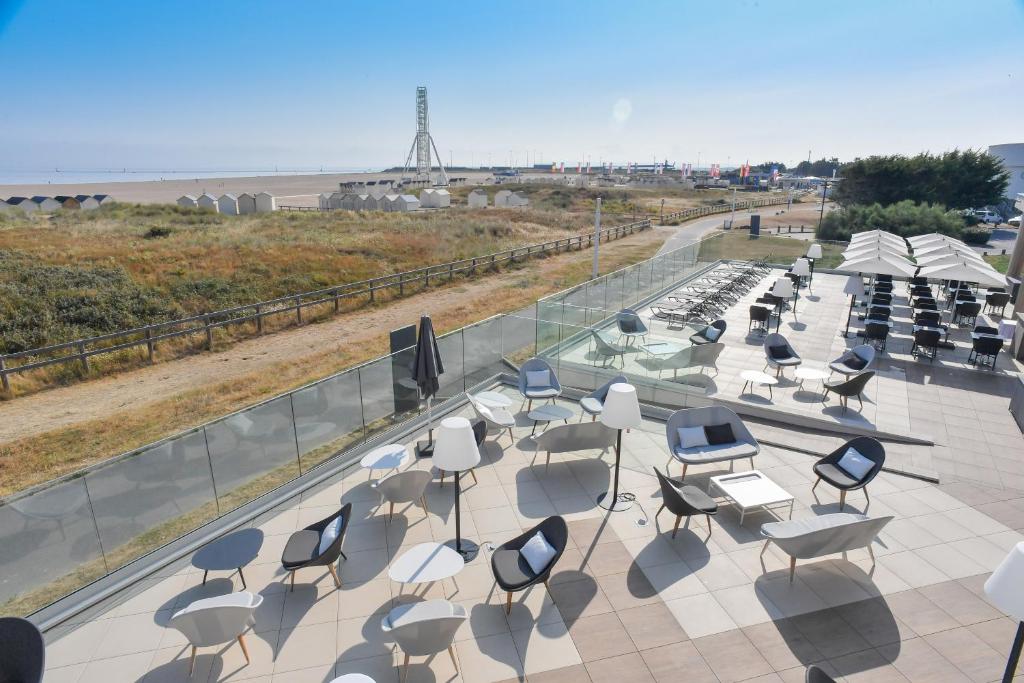 a group of chairs and tables on a roof at Thalazur Ouistreham - Hôtel & Spa in Ouistreham