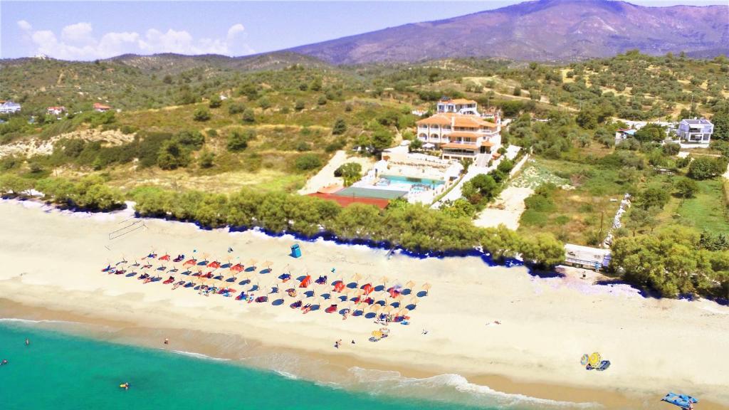 an aerial view of a beach with a group of chairs at Thassos Hotel Grand Beach in Limenaria
