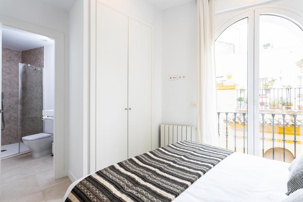 Łóżko lub łóżka w pokoju w obiekcie Genteel Home Mateos Gago
