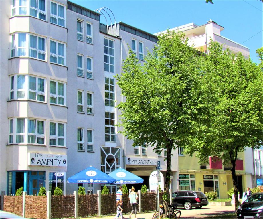a building on a city street with people walking in front of it at Hotel AMENITY in Munich