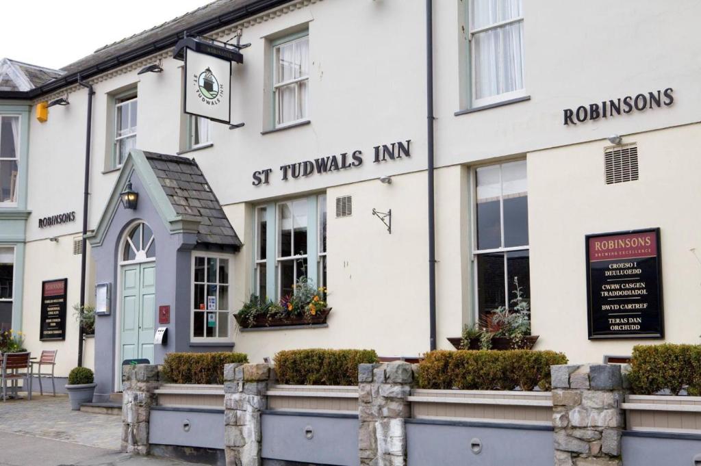 a large brick building with a clock on the front of it at St Tudwals Inn in Abersoch