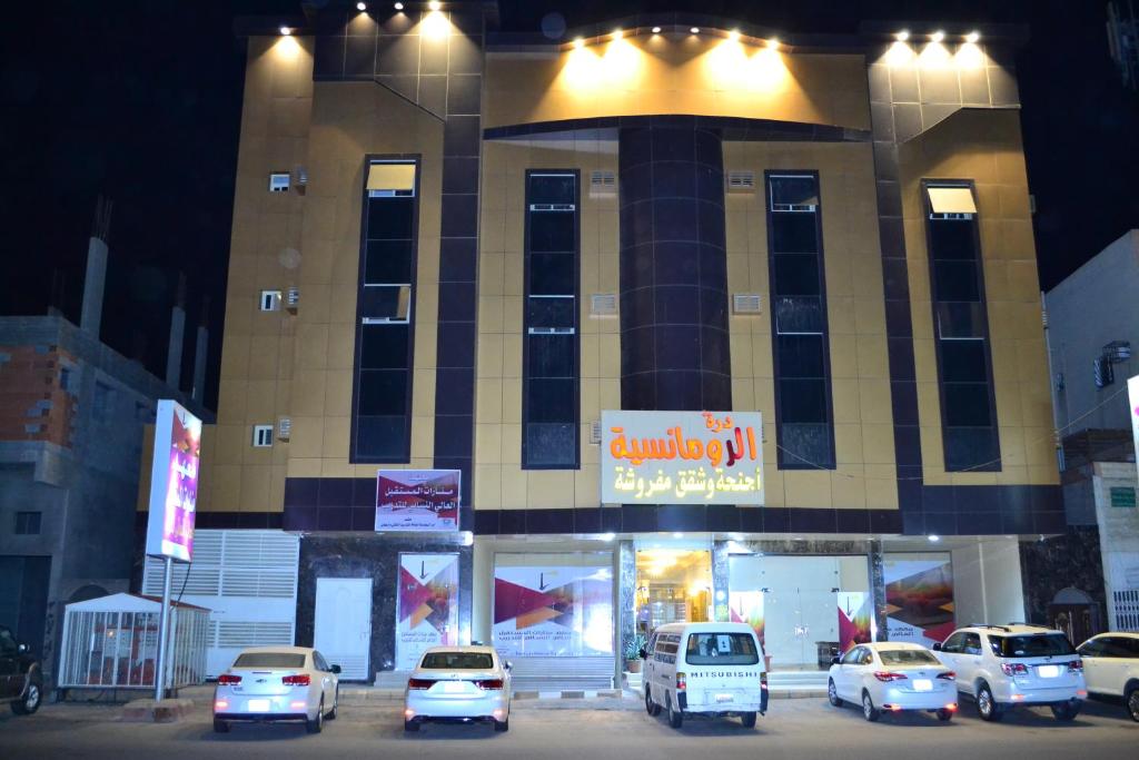 a group of cars parked in front of a building at Durat Al Ruwmansiya 3 in Tabuk