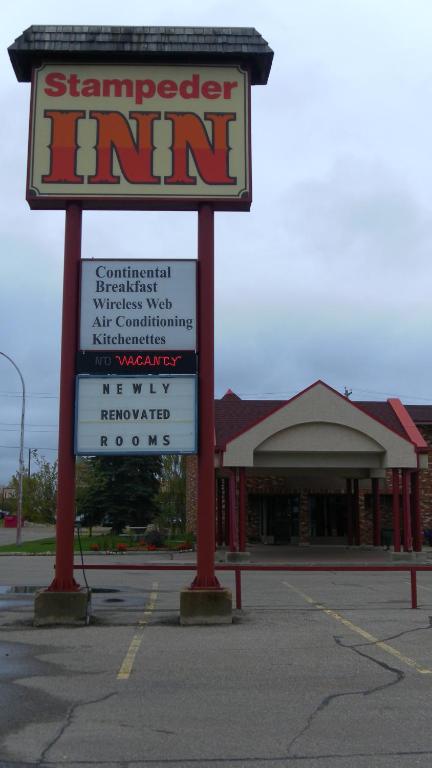 a sign in a parking lot in front of a store at Stampeder Inn in Ponoka