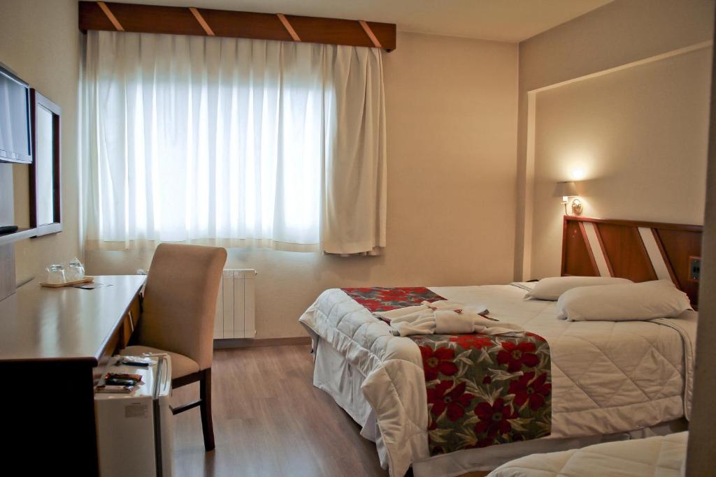 Säng eller sängar i ett rum på São Joaquim Park Hotel