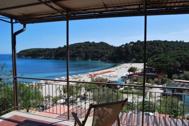 a balcony with a view of a beach and the ocean at Appartamenti Fetovaia Elicriso in Fetovaia