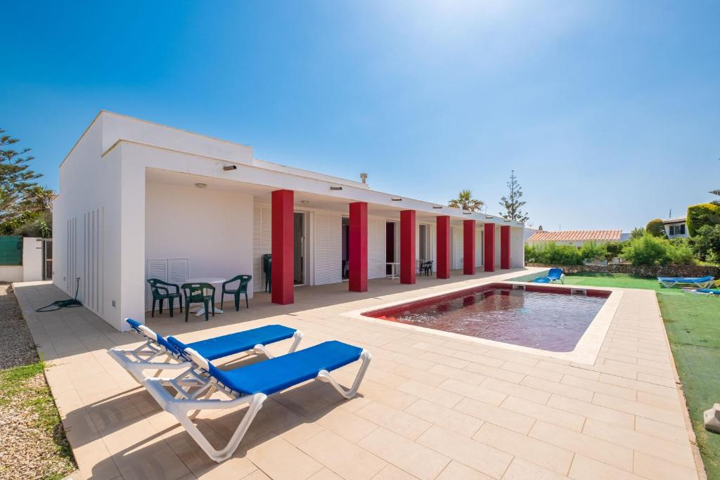 a patio with two lounge chairs and a pool at Villa en Menorca in Mahón