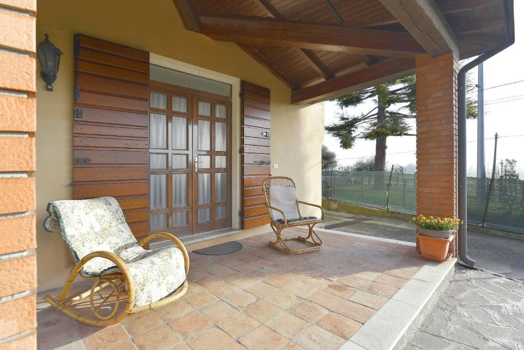 duas cadeiras sentadas no alpendre de uma casa em Casa Nonna Rina em Monzambano