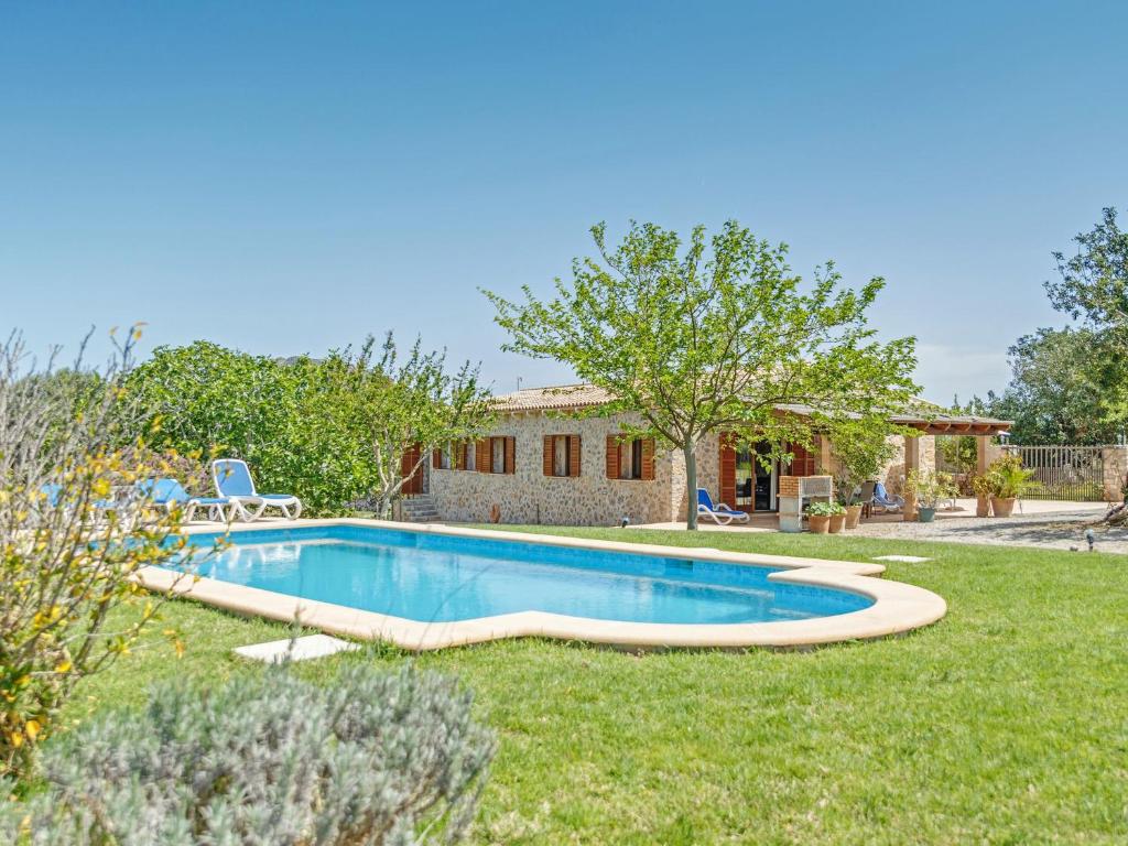 a swimming pool in the yard of a house at Mamici in Capdepera