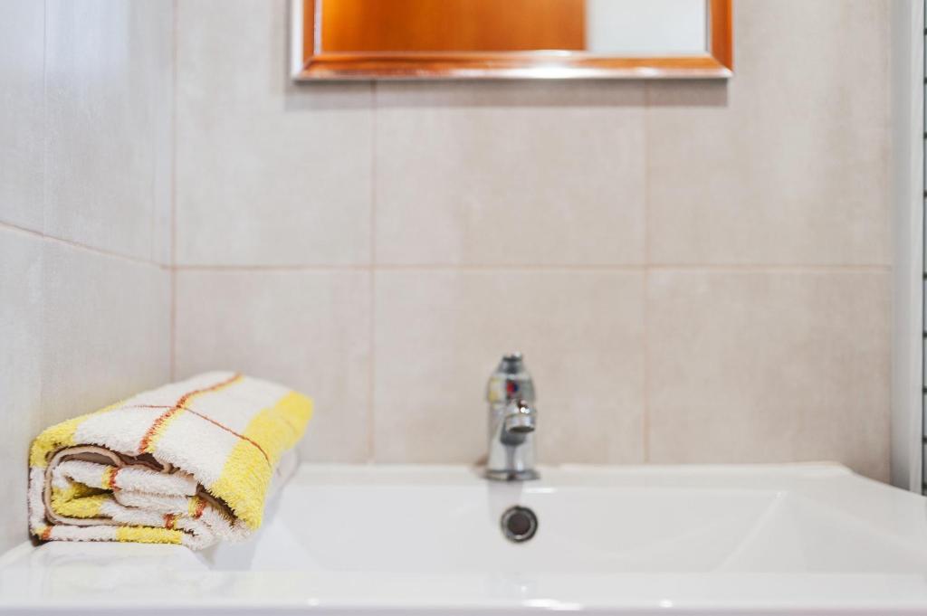 a bathroom with a sink with a towel on it at Las tres hermanas in Conil de la Frontera
