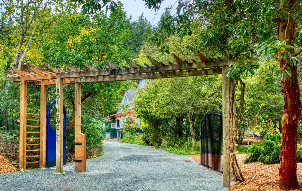 a wooden pergola with a gate on a road at Sehome Garden Inn in Bellingham