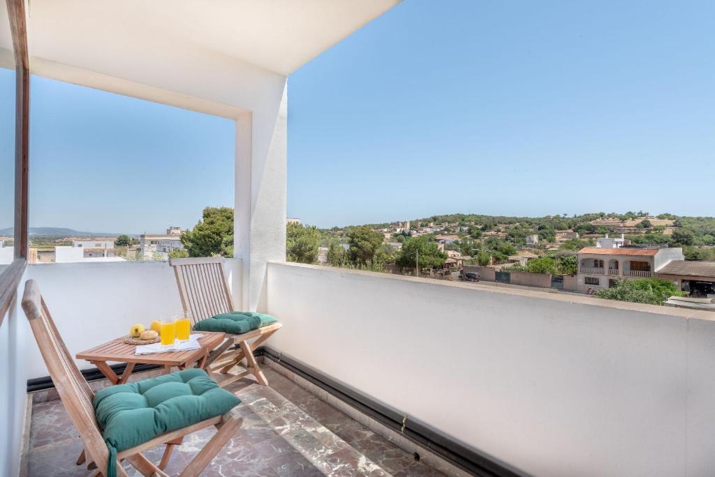 a balcony with a table and chairs and a large window at Bennassar 2 in Felanitx