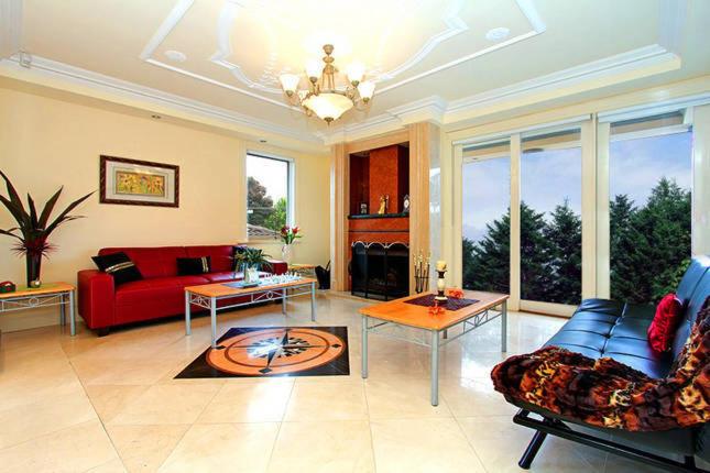 a large living room with a red couch and tables at ABC Accommodation - Rosebud in Rosebud