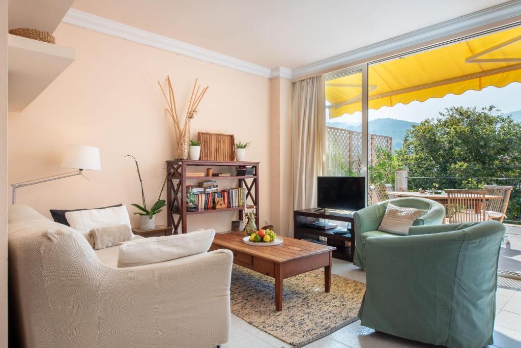 a living room with two chairs and a table at Apartament Carla in Port de Soller