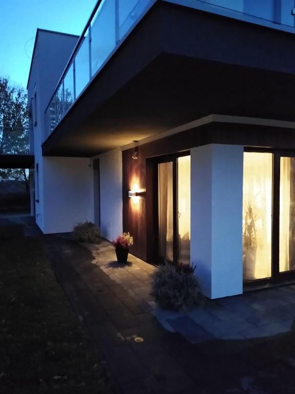 a house with a light on the side of it at Green Ravine in Nałęczów