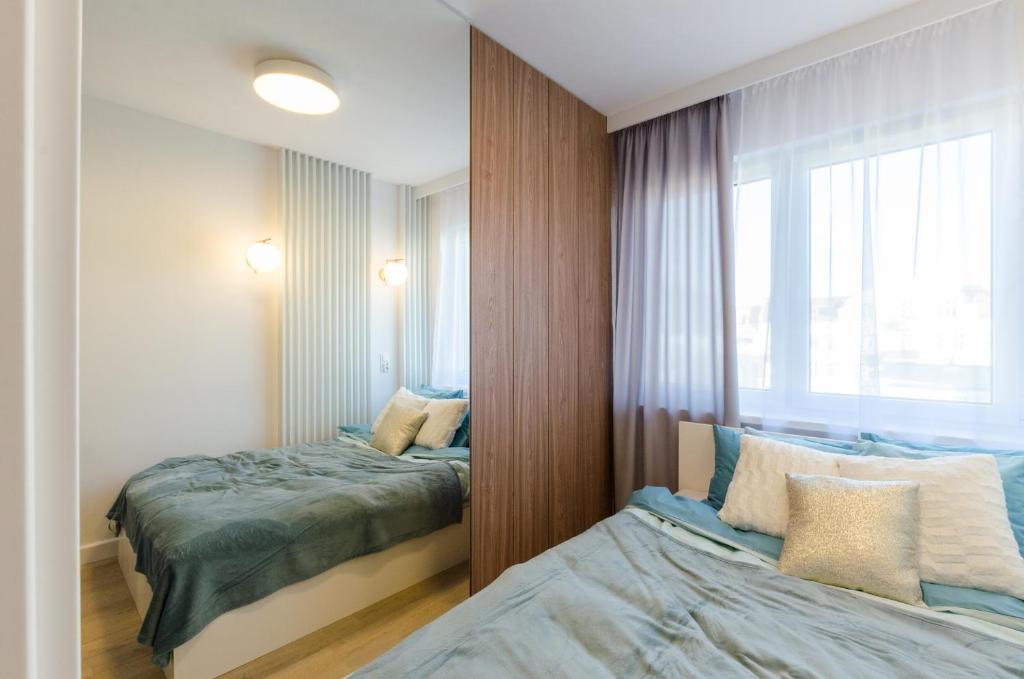Posteľ alebo postele v izbe v ubytovaní Apartament Różana