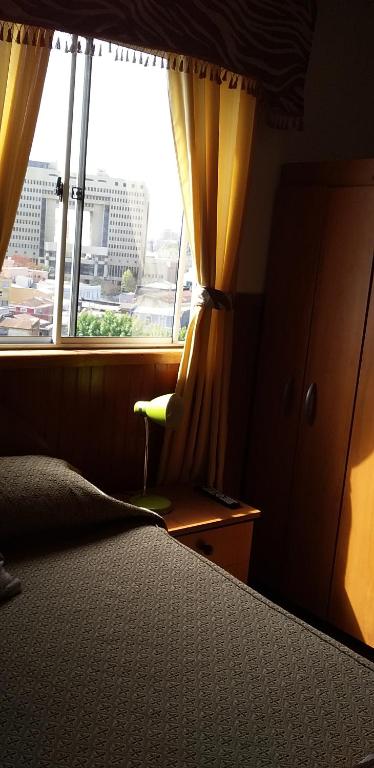Postel nebo postele na pokoji v ubytování Hostal Tunquelen