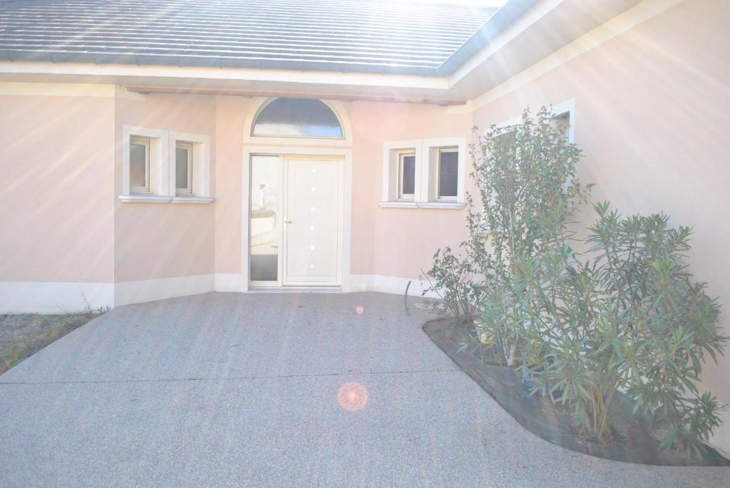 a front door of a house with a plant at VILLA KÉRINÉ in Valencin