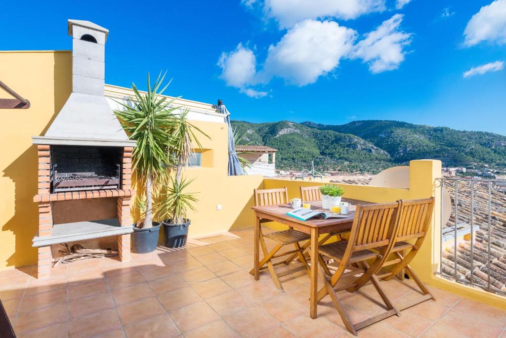 a patio with a table and chairs on a balcony at Eliasneil in Andratx