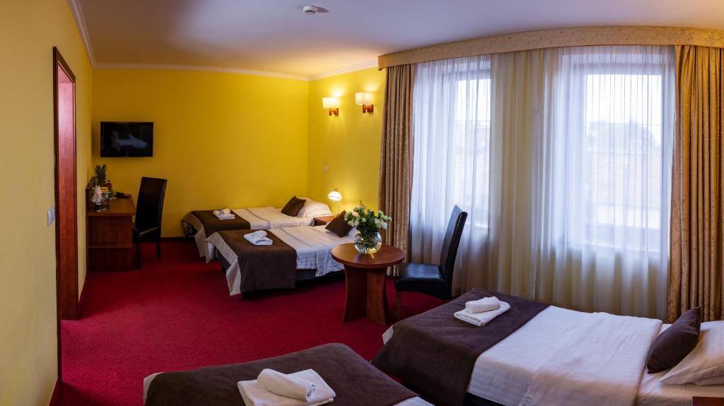 Postel nebo postele na pokoji v ubytování Hotel Piotr Spa&Wellness